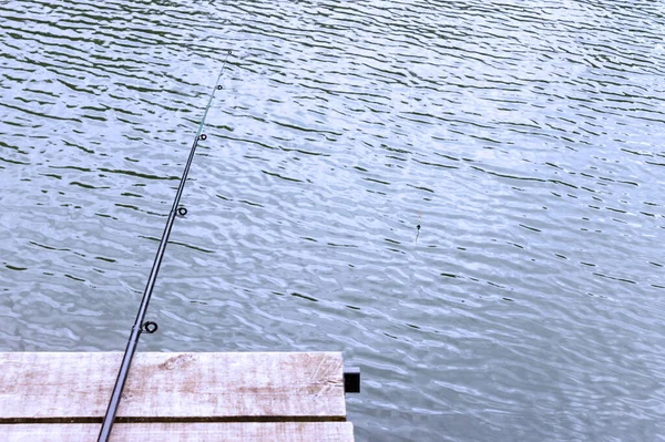 Una Canna Pesca Sdraiato Molo Legno Appeso Sopra Acqua Concetto — Foto Stock