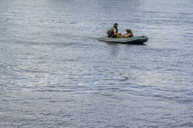 Rusya, Mytishchi, 12.06.2020. Can yelekli iki kişi, bir adam ve bir kadın küçük bir teknede yüzüyorlar. Deniz taşımacılığı ve suyun üzerindeki güvenlik kavramı. Sadece editör kullanımı