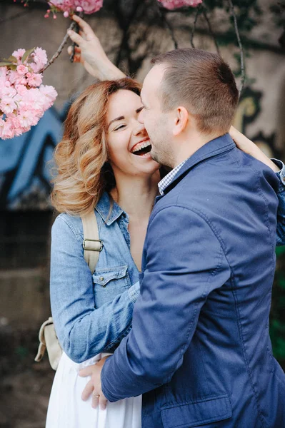 couple in love in a blooming Apple orchard lying on the blanket