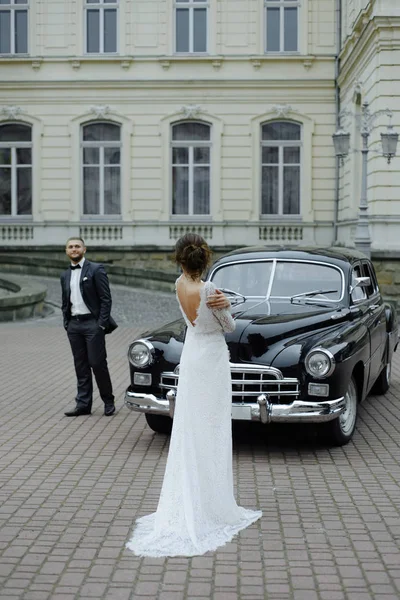 Beautiful retro couple against vintage car