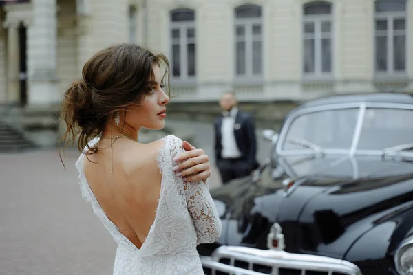 the groom in a gray suit and the bride in a gray dress look at each other, closeup portrait