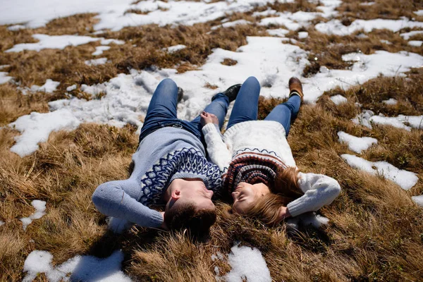 Jeune couple relaxant sur la neige — Photo
