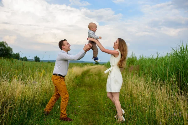 Parents throw their one-year-old son into the sky.