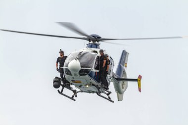 TORRE DEL MAR, MALAGA, SPAIN-JUL 31: Helicopter Eurocopter EC-135 of the police taking part in a exhibition on the 1st airshow of Torre del Mar on July 31, 2016, in Torre del Mar, Malaga, Spain clipart