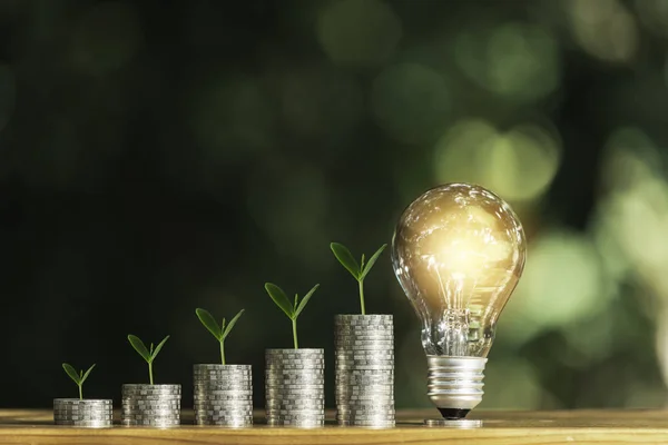 Light bulb with stack of coins and copy space for accounting, bu