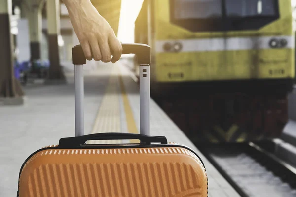 Mujer arrastrando maleta naranja maleta de equipaje, caminando en tren sta —  Fotos de Stock