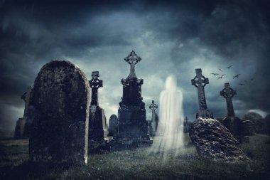 Spooky old graveyard and a ghost at night clipart