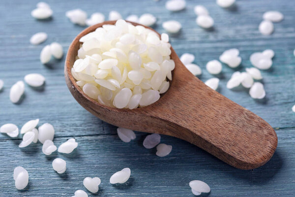 Beeswax pellets in the spoon