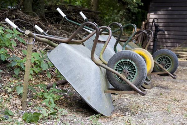 Wheelbarrows Row Wooden Wall — Stock Photo, Image