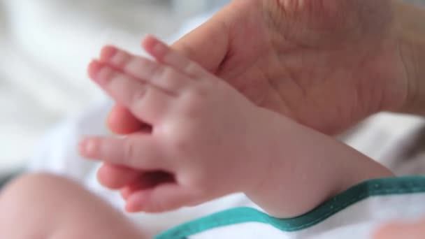 Mãe segurando a mão do bebê. Mão de bebê recém-nascido em mãos de mãe — Vídeo de Stock