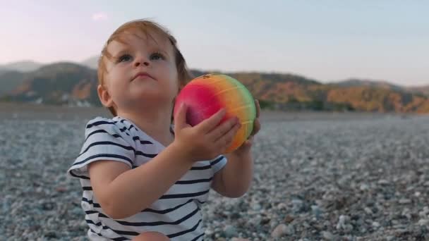 Cute Little Baby Girl Colorful Ball Hands Sitting Beach Summer — Stock Video