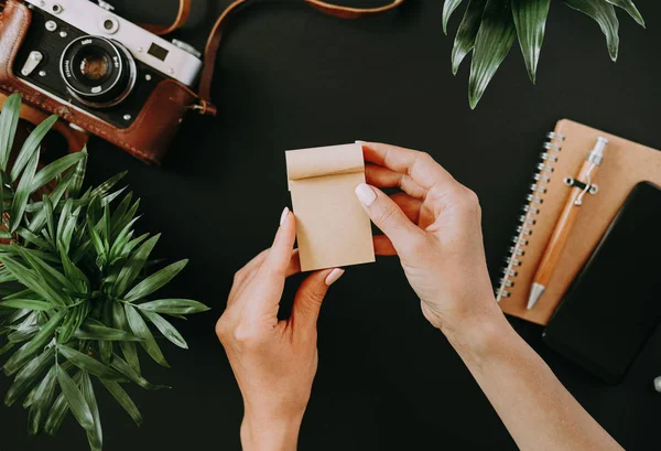 Top view of flat lay female hand leafing notebook — Stock Photo, Image