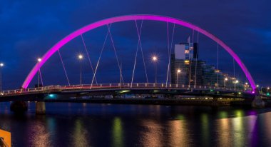 GLASGOW, SCOTLAND - JULY 21: The Clyde Arc bridge over the river Clyde at night on July 21, 2017 in Glasgow, Scotland. Glaswegians call the bridge the 'Squinty Bridge'.