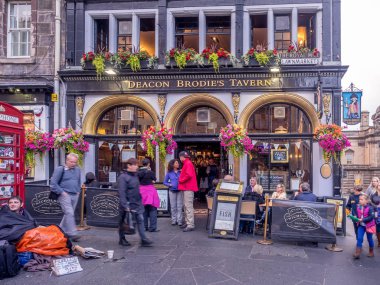 EDINBURGH, SCOTLAND - JULY 28: Deacon Brodie's Pub along the Royal Mile on July 28, 2017 in Edinburgh, Scotland. There are many such pubs on the Royal Mile serving tourists with whisky, beer, etc. clipart