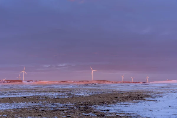 Windmills on a prairie horizon at sunset. Location is the small town of Dalham close to Drumheller, Alberta Canada.