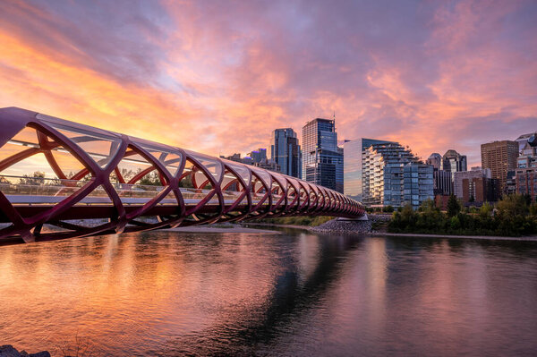 View of pedestrian bridge over the Bow River in Calgary Alberta at sunrise.