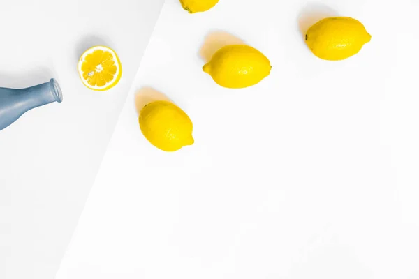 Water Bottle Few Lemons Pastel Grey White Background Flat Lay — Stock Photo, Image