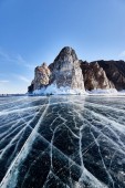 Картина, постер, плакат, фотообои "lake baikal in winter. beautiful rocky island on a background of blue sky and smooth ice with cracks ", артикул 251718874
