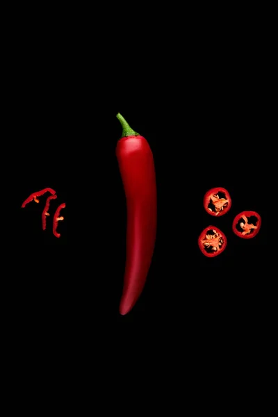 Seamless pattern with red hot chili peppers. Vegetables abstract background. Food collage, slicing hot red chili peppersRed hot chili peppers on a black background.