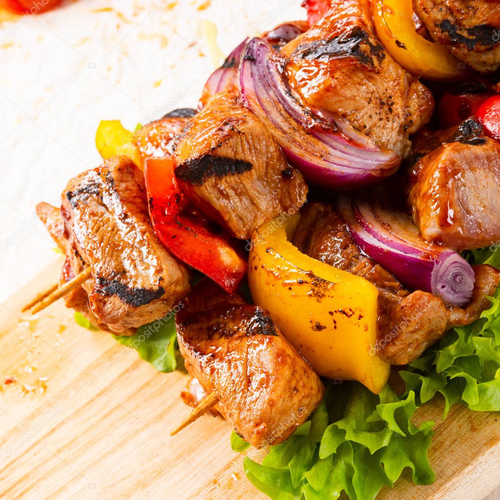 tasty and colorful meat skewers with peppers and onions