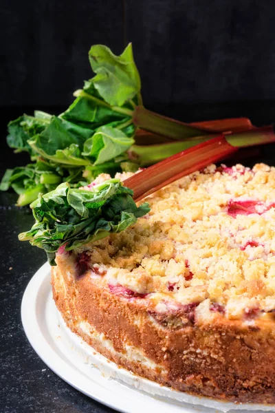 delicious rhubarb cake with crumble on cake stand