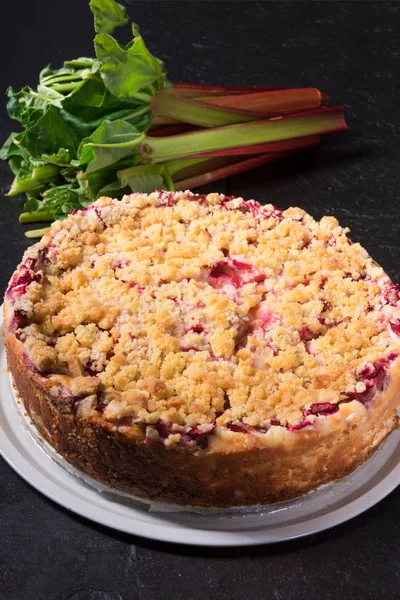 delicious summery rhubarb cake with crumble on cake stand