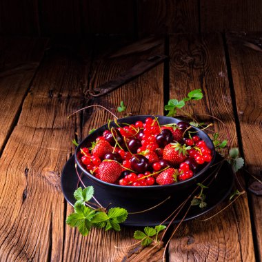 Çilek, frenk üzümü ve kiraz gibi farklı meyve ile kase.