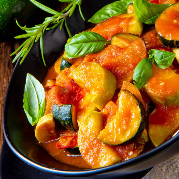 close up of vegetarian ratatouille with fresh vegetables and herbs