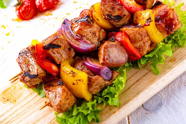 tasty and colorful meat skewers with peppers and onions