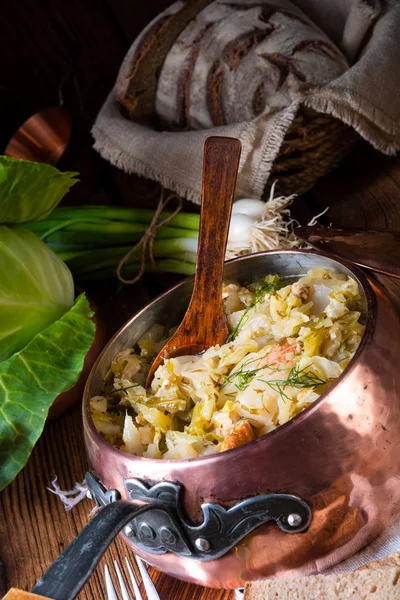 young and fresh cabbage cooked with bacon cubes