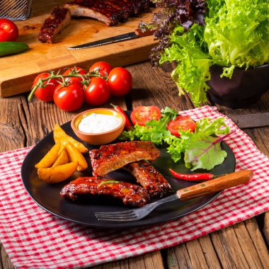 Barbekü kaburga plaka yeşil salata ve beyaz sos ile