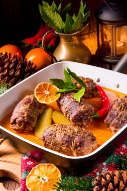 Kışlıklar sığır eti roulades, Erik ve pastırma doldurma ve beyaz kase içinde salatalık ile