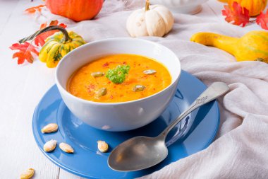 Zencefilli havuç ve kabın içinde Hindistan cevizi sütü ile sağlıklı kabak çorbası 