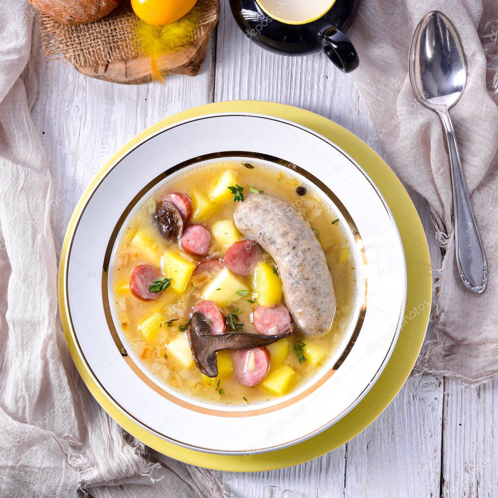 a polish easter soup with homemade white sausage and mushrooms