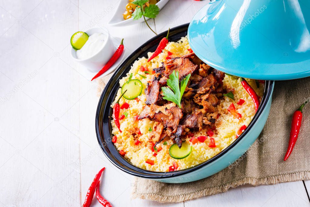 Tajin with couscous, vegetables and meat on white backgroun