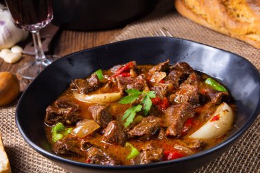 classic beef goulash with peppers and onions clipart