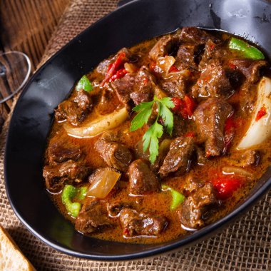 classic beef goulash with peppers and onions clipart