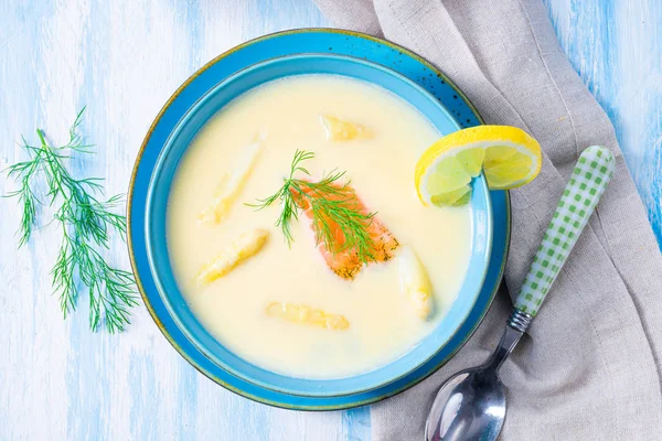 Cream of asparagus soup with salmon rolls and dill — Stock Image Cream of asparagus soup with salmon rolls and dill Stock Photo
