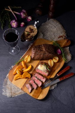 Rus usulü tereyağlı biftek, otlar ve patates dilimleri.