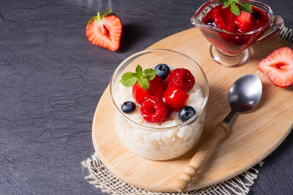 Delicious milk rice with different berries and red fruit jelly — Stock Photo, Image