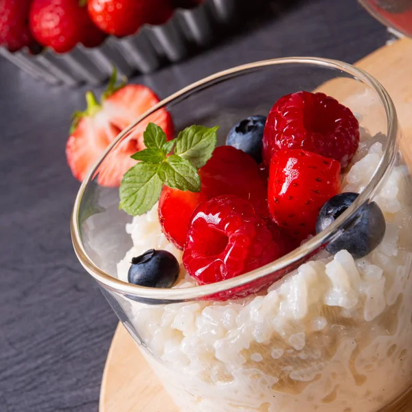 Delicious milk rice with different berries and red fruit jelly — Stock Photo, Image