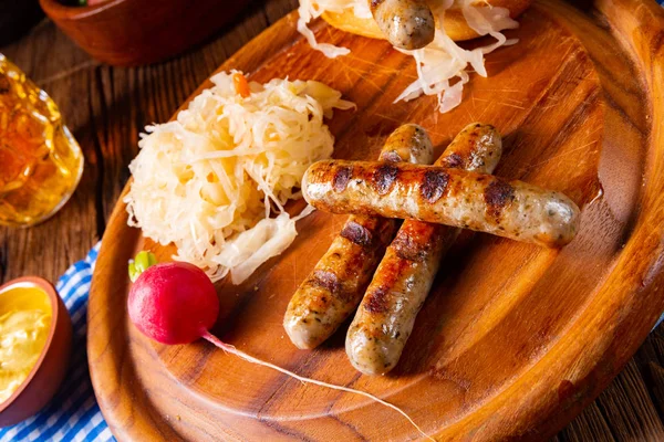 Rustic Thuringian bratwurst with sauerkraut and roll — Stock Photo, Image