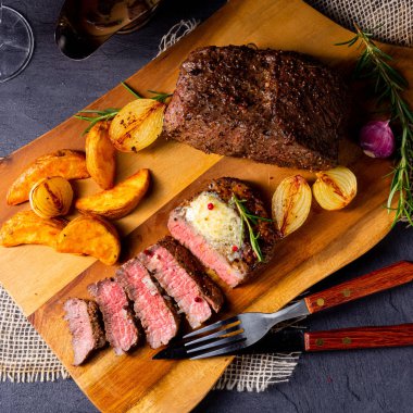 Rus usulü tereyağlı biftek, otlar ve patates dilimleri.