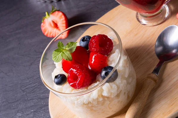 Delicious milk rice with different berries and red fruit jelly — Stock Photo, Image