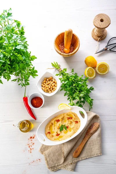 stock image hummus paste with lemon and chilli on white background