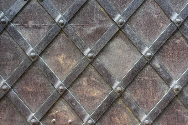 Fragment of a metal door with rivets — Stock Photo, Image