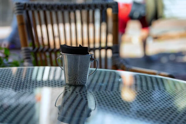 Bucket with napkins on a cafe table — Stock Photo, Image