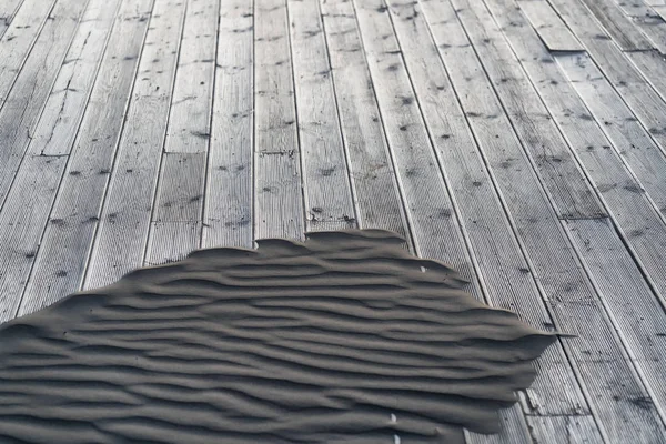 Sand on a wooden terrace on the beach — Stock Photo, Image