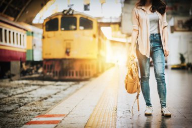 Tren istasyonunda duran kadın gezgin turist. Aktif ve seyahat yaşam tarzı kavramı
