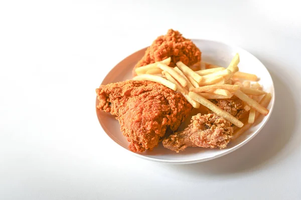 fried chicken and fries on white plate